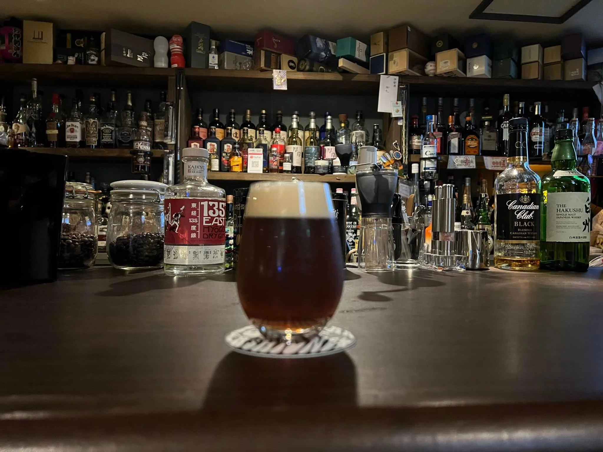 Inside the night counter, with dishes and glasses lined up and a record player visible in the back