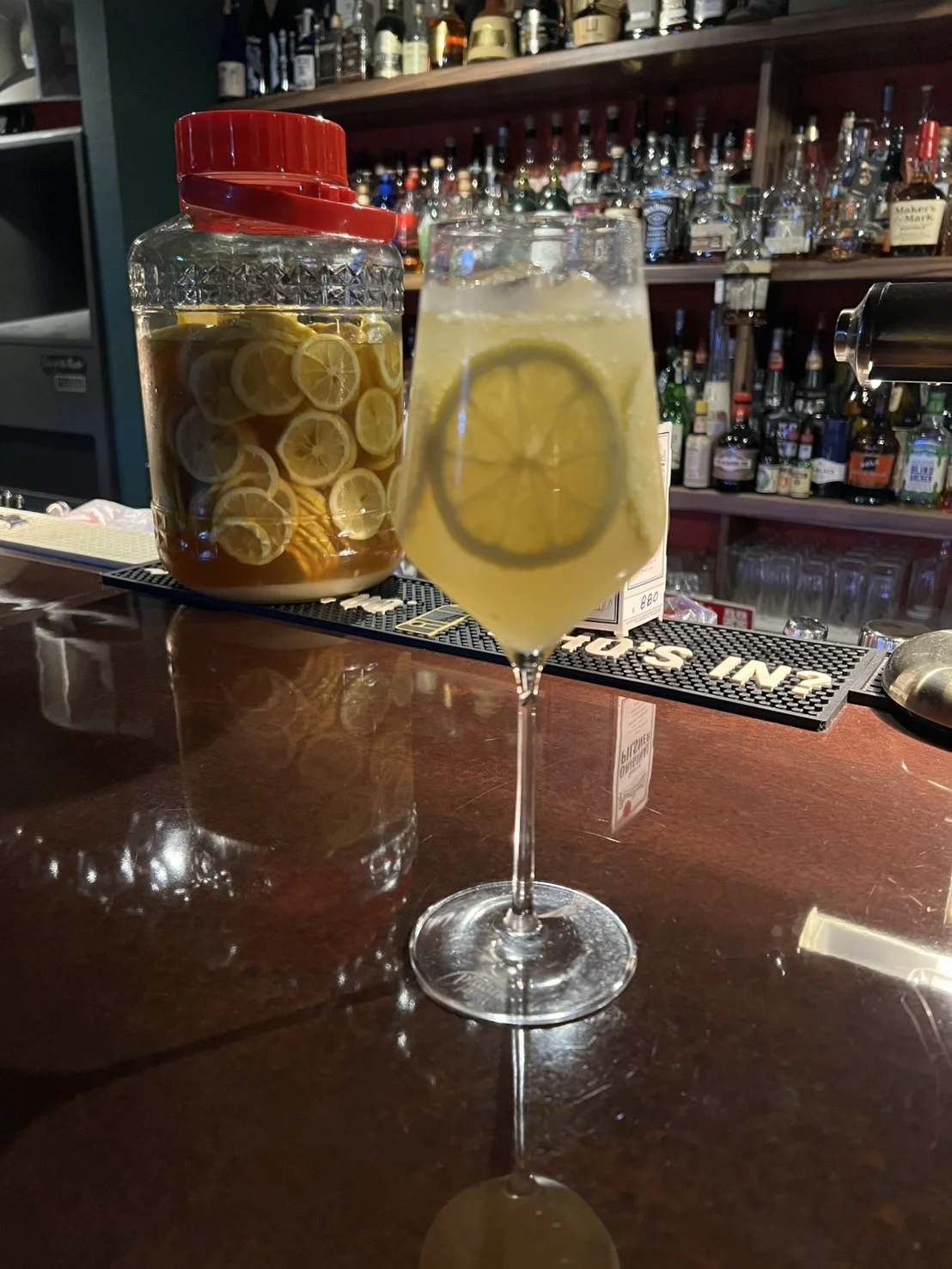 Seasonal cocktails with citrus and herbs, along with non-alcoholic drinks, arranged on a wooden table
